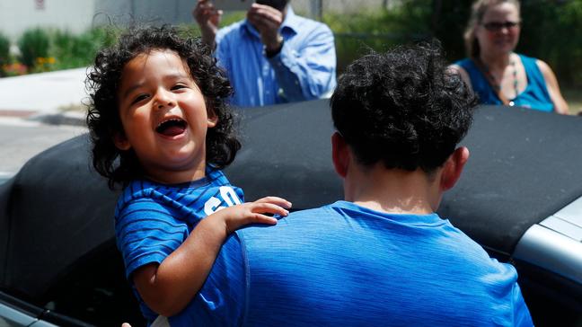 Reunited immigrant children scooped up into parents' arms